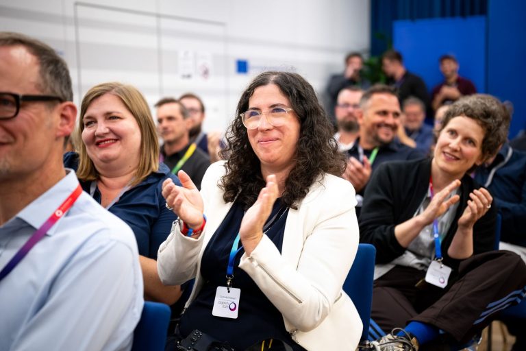 Gäste im Publikum klatschen und lächeln